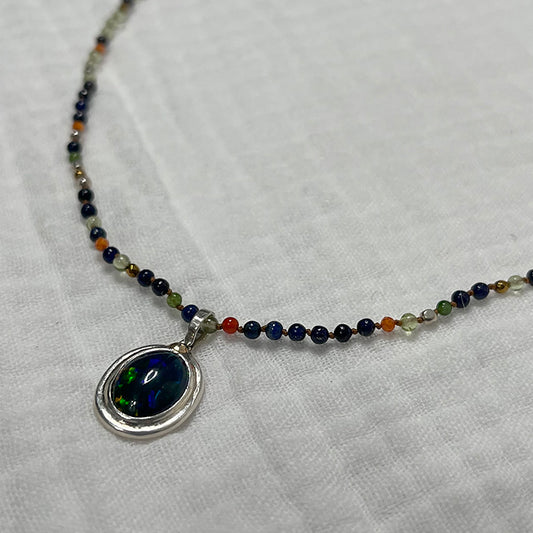 Ethiopian smoked fire opal 1.4ct oval pendant on beads